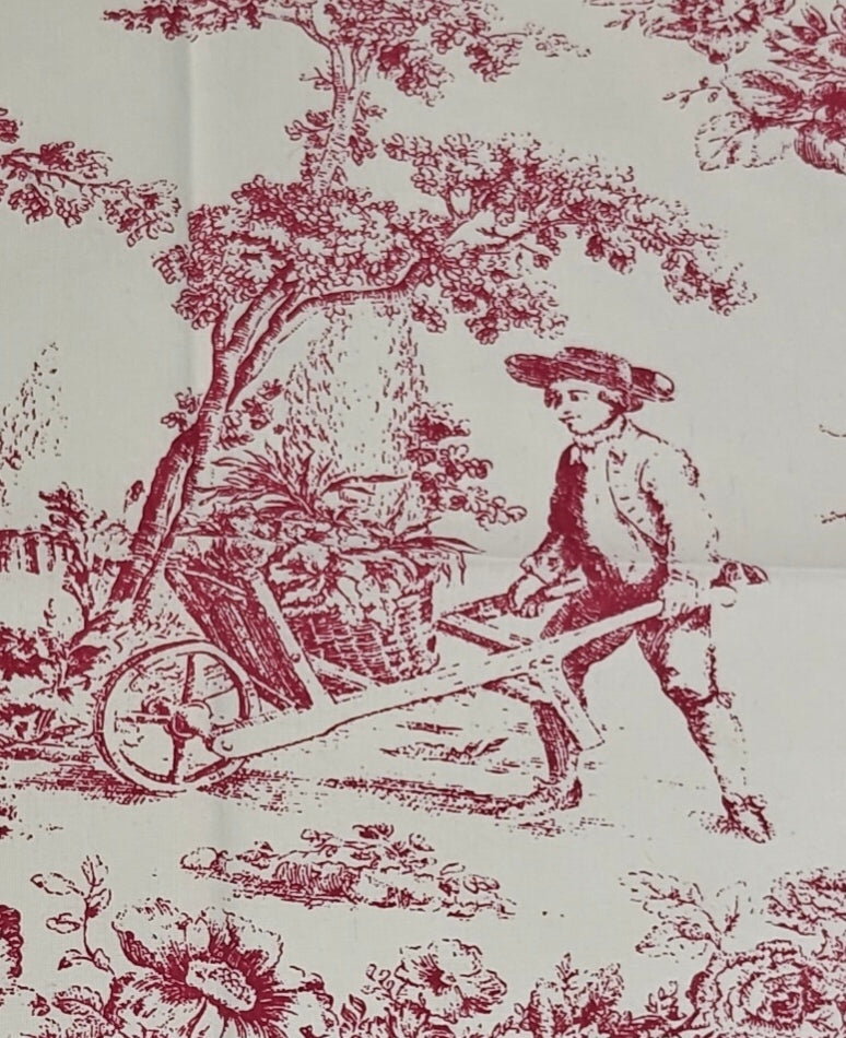 Vintage-style fabric print with a red and black scene of a boy with a wheelbarrow and a woman in a garden.