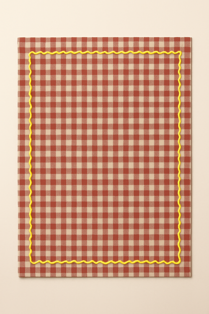 Red and white checkered towel with yellow border on a beige background
