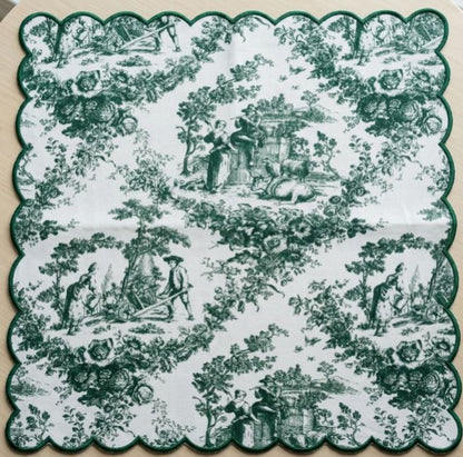 Decorative green and white patterned napkin with pastoral scenes