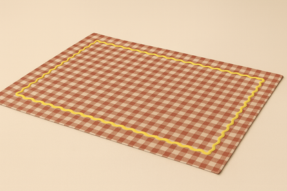 Checkered placemat with yellow border on a beige background