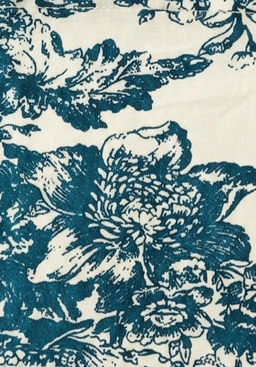 Floral patterned fabric with blue flowers on a white background