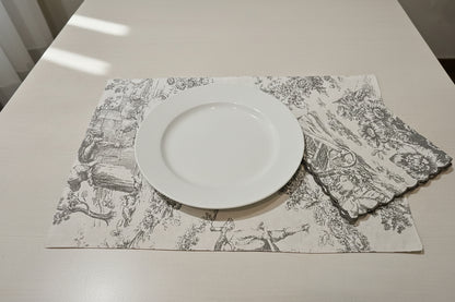 White plate on a decorative placemat with a floral pattern on a white table.