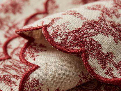 Close-up of red embroidery on beige fabric