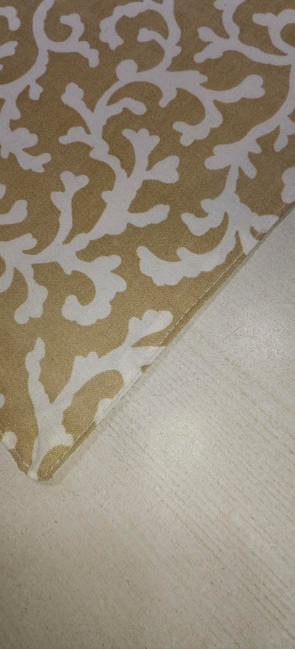 Close-up of golden floral cotton fabric - Viraasa luxury dining