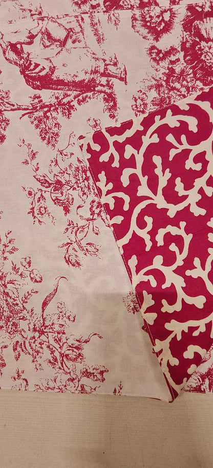 Fabric with red and white floral Placemats on a wooden surface