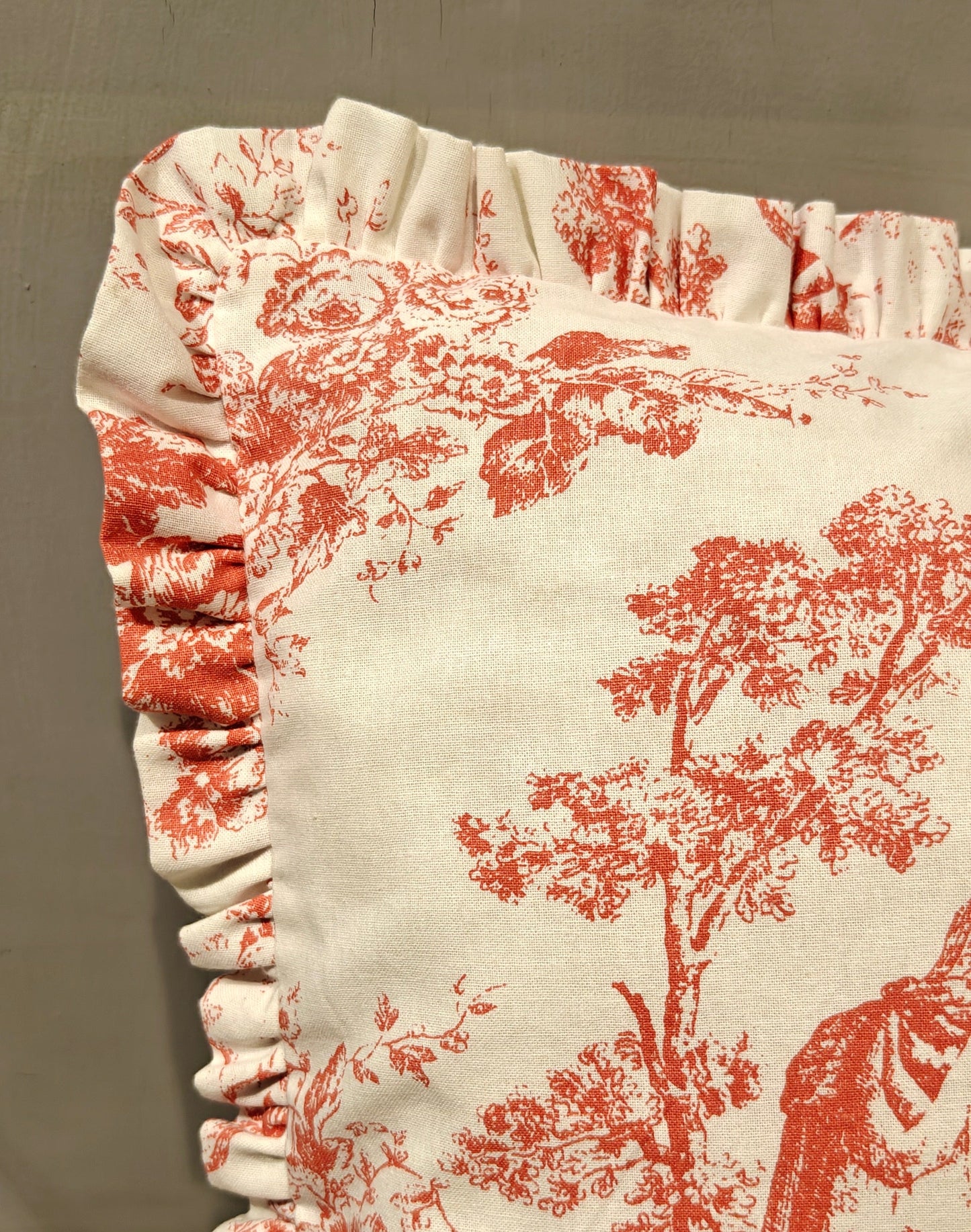 Close-up of brick pink Toile pattern on cushion - Viraasa