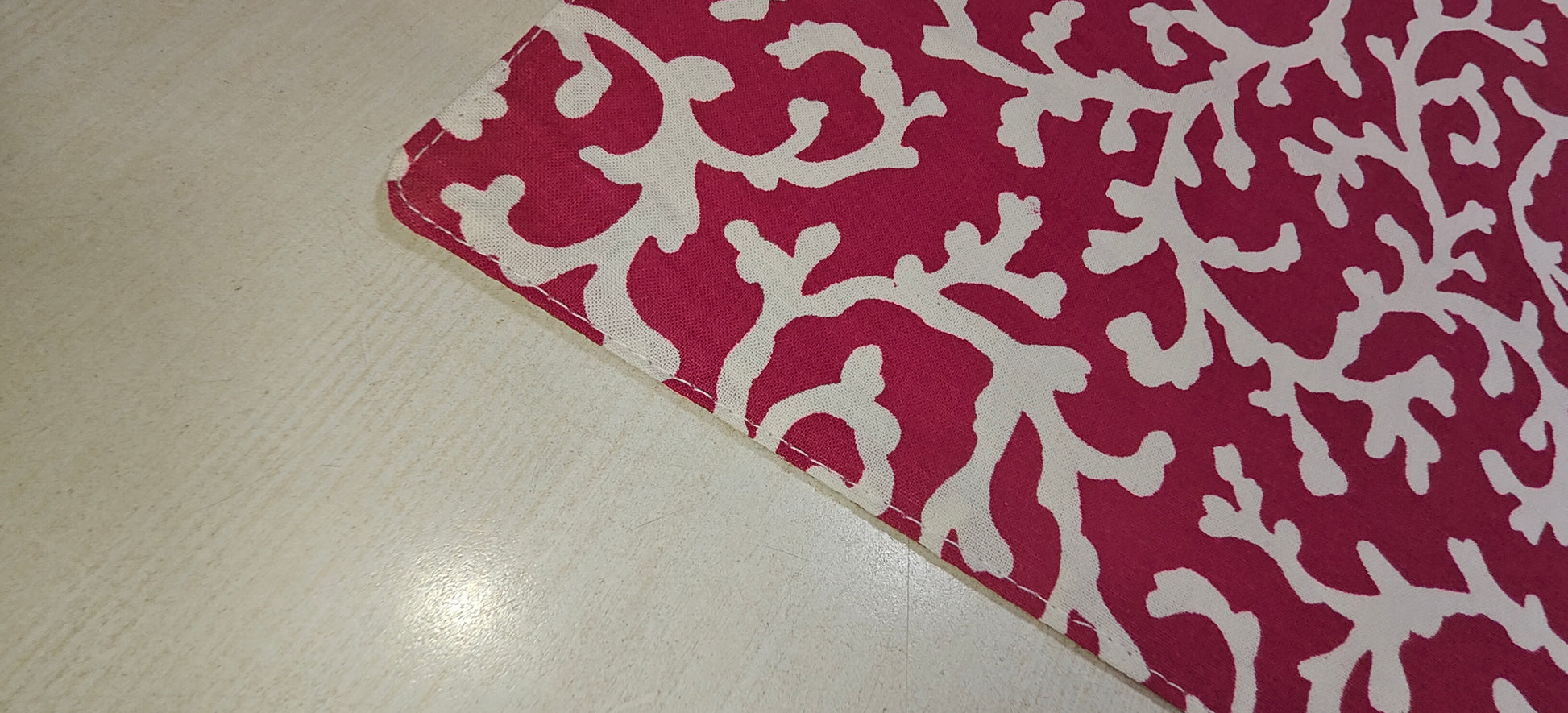 Close-up of red floral cotton fabric - Viraasa luxury dining
