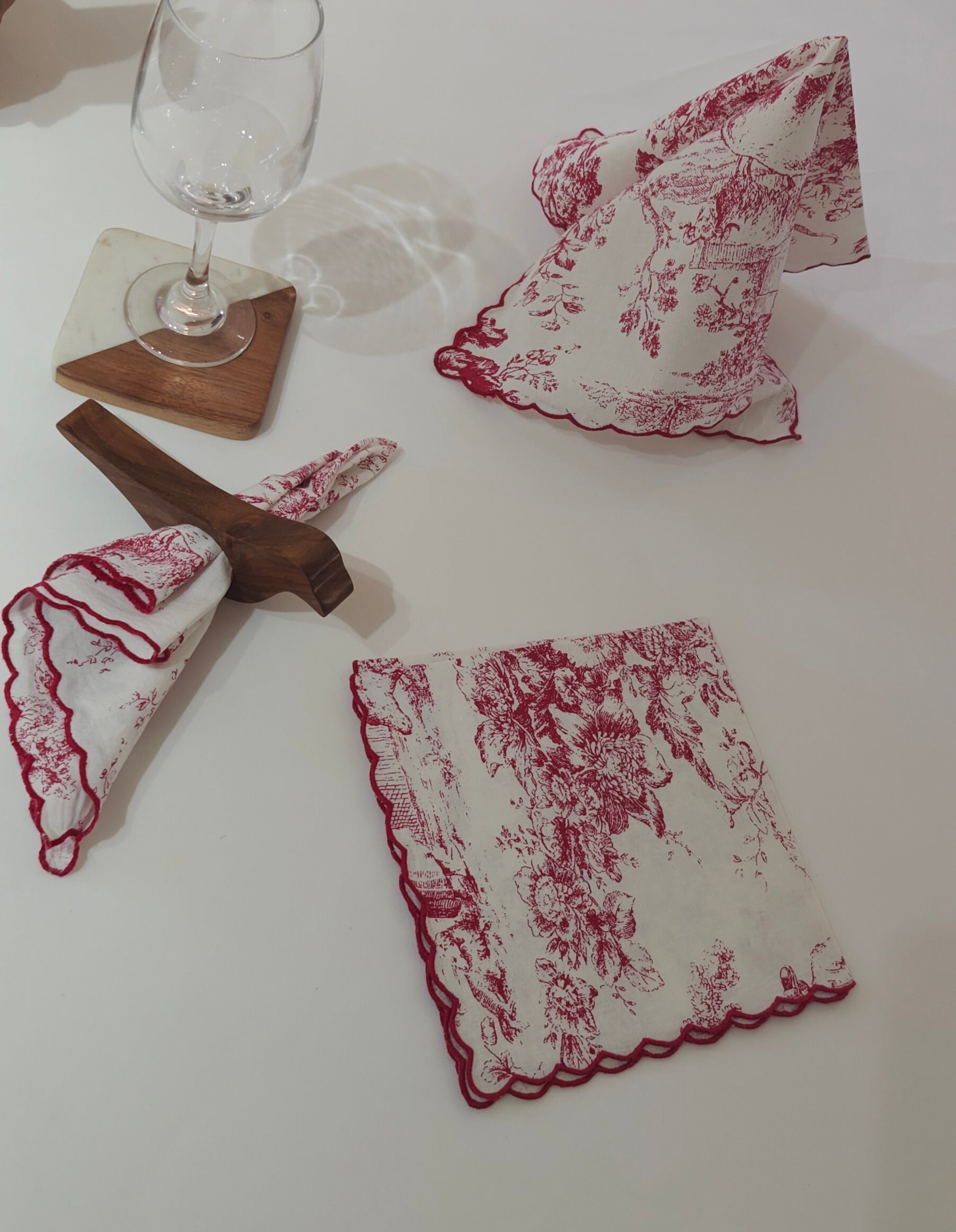 Embroidered scalloped edge close-up on red napkin - Viraasa