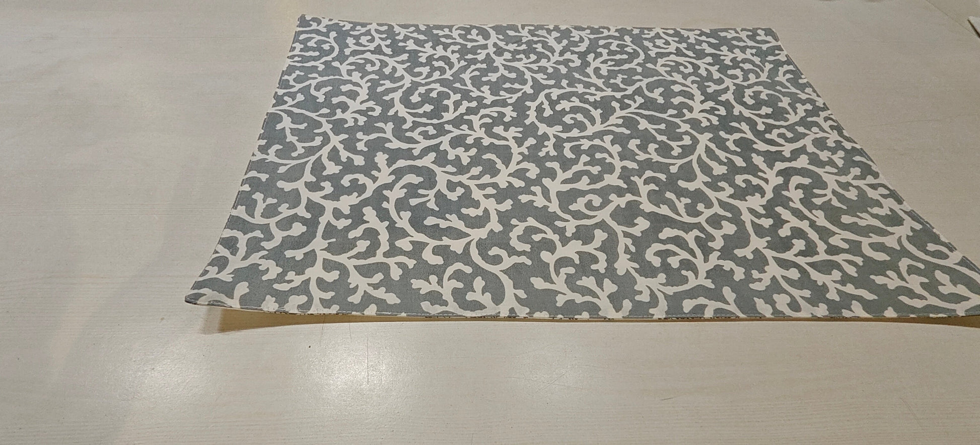 Grey floral placemats styled on dining table - Viraasa