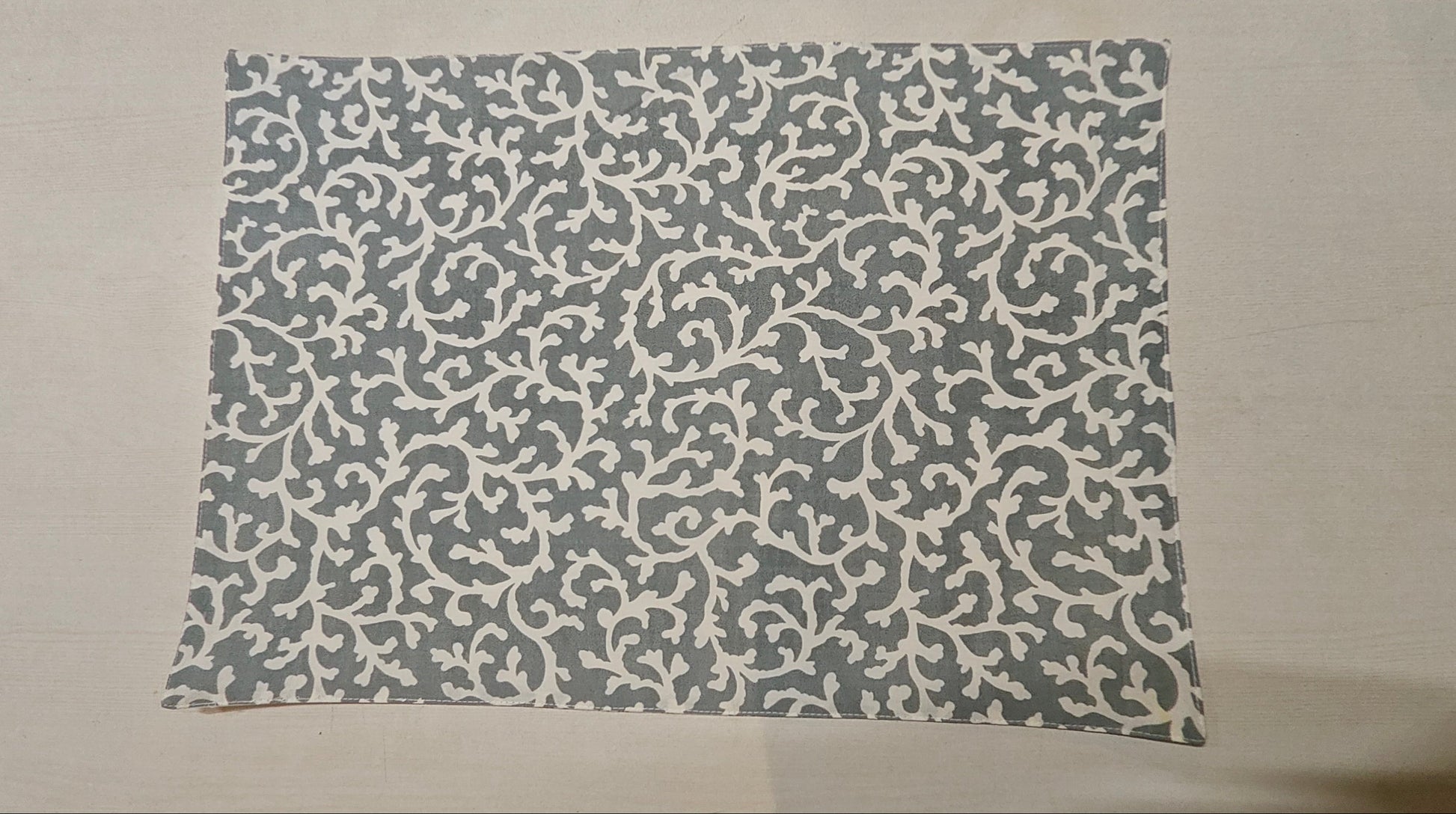 Rectangular mat with a gray pattern on a beige background
