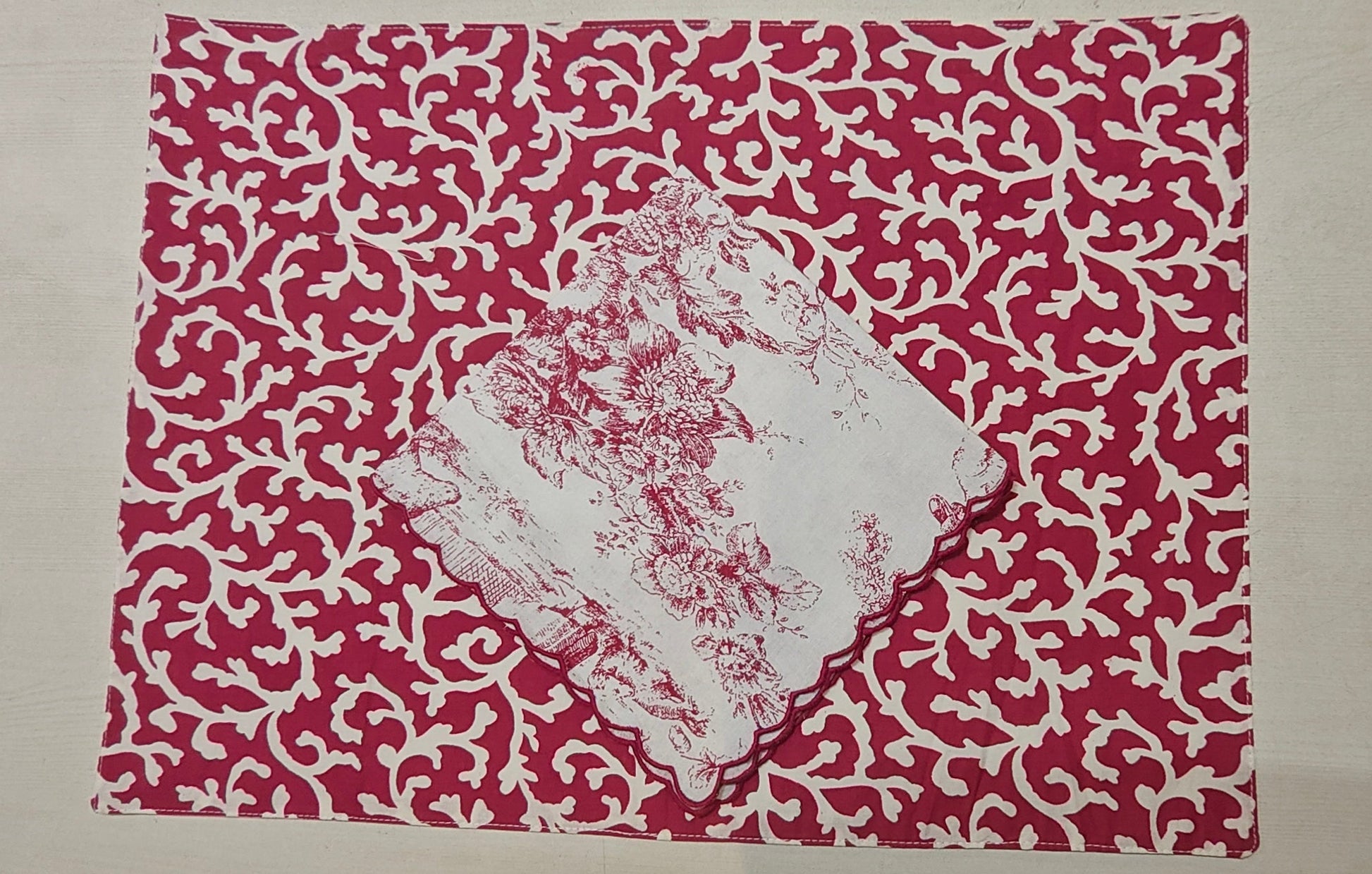 Stack of red floral placemats - Viraasa luxury home