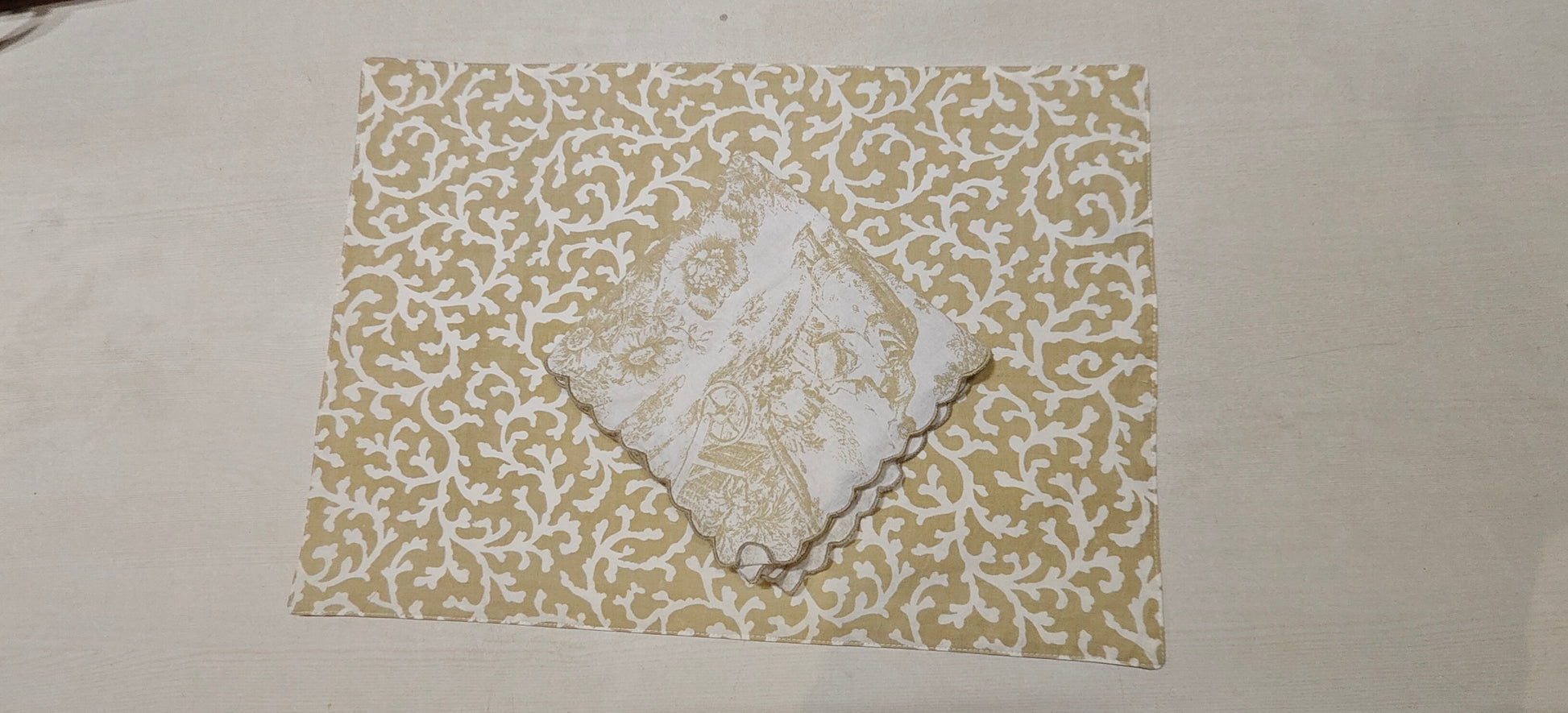 Stack of golden floral placemats - Viraasa luxury home