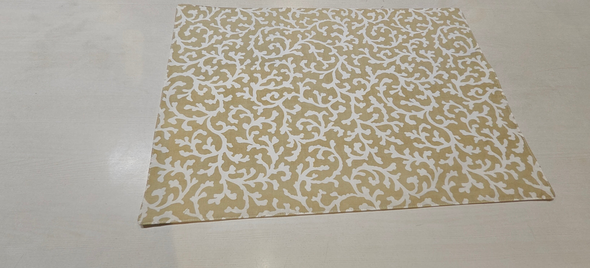 Golden floral placemats styled on dining table - Viraasa