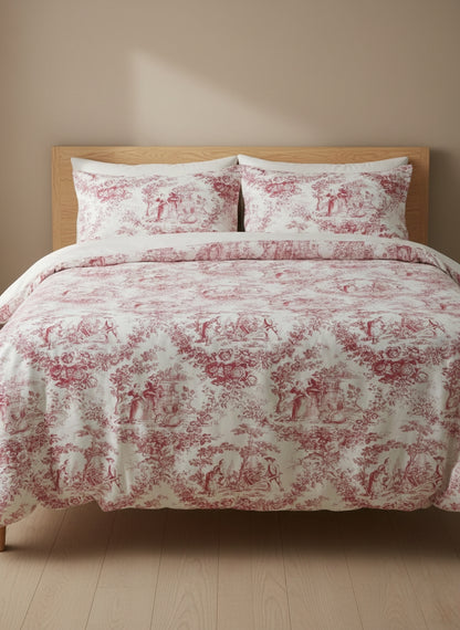 Bed with red and white patterned bedding on a wooden bedframe against a beige wall.